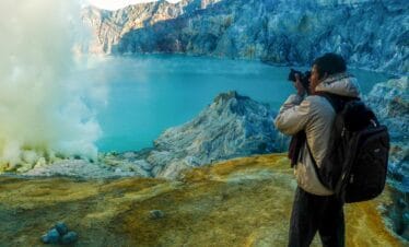 Ijen sunrise photography showing golden light over the turquoise crater lake in East Java