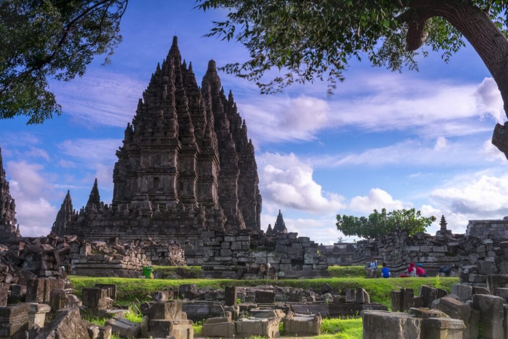 Prambanan Temple complex in Yogyakarta under a bright blue sky, showcasing ancient Hindu architecture during a Yogyakarta temple tour.