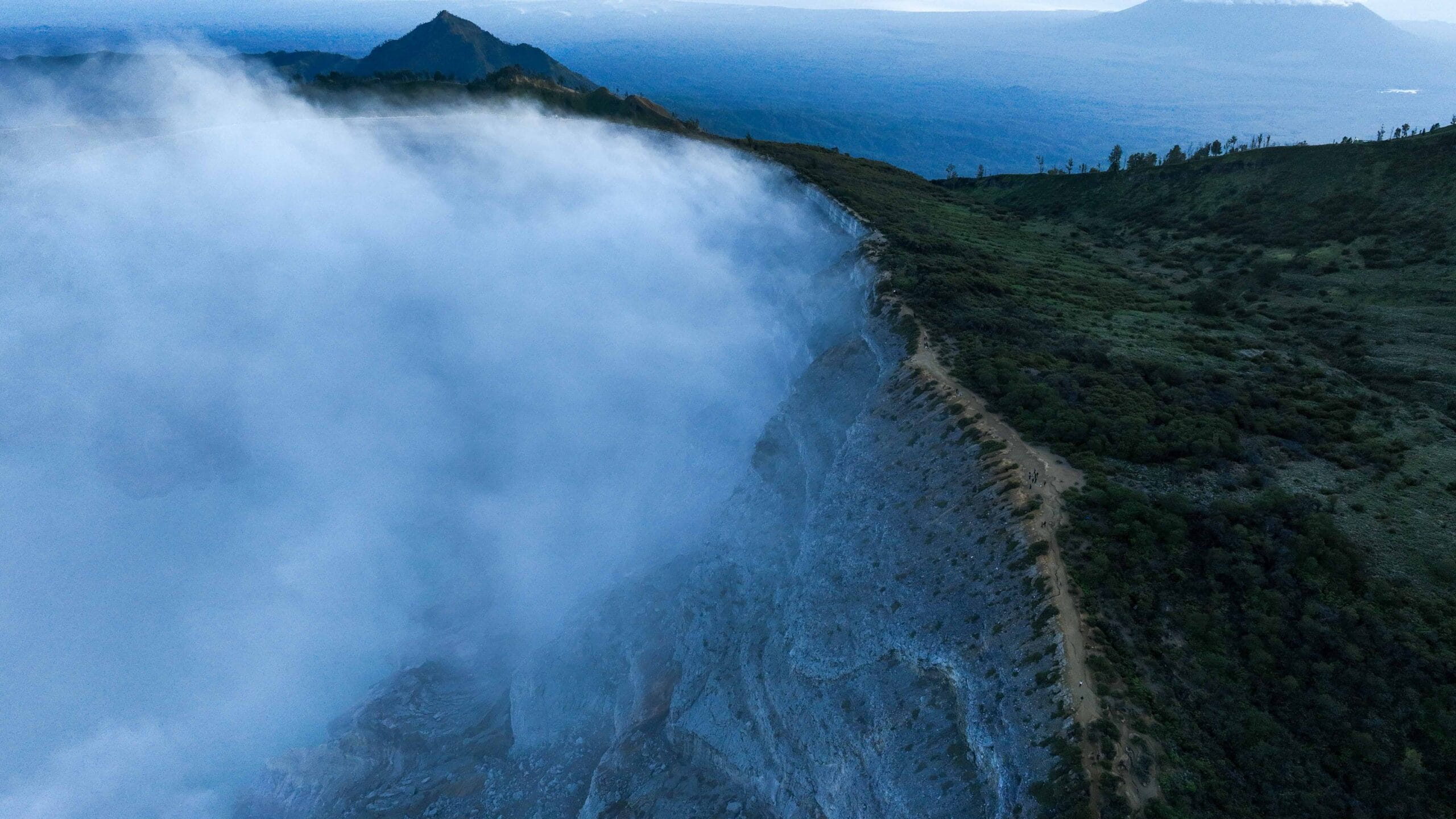 Aerial view of Mount Ijen crater at dawn, showcasing best camera settings for Ijen sunrise with vivid sky and turquoise lake.
