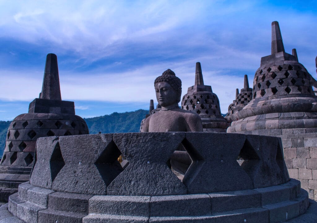 Borobudur Temple stupas standing against a clear blue sky, an iconic stop for travelers exploring Yogyakarta temple tours.