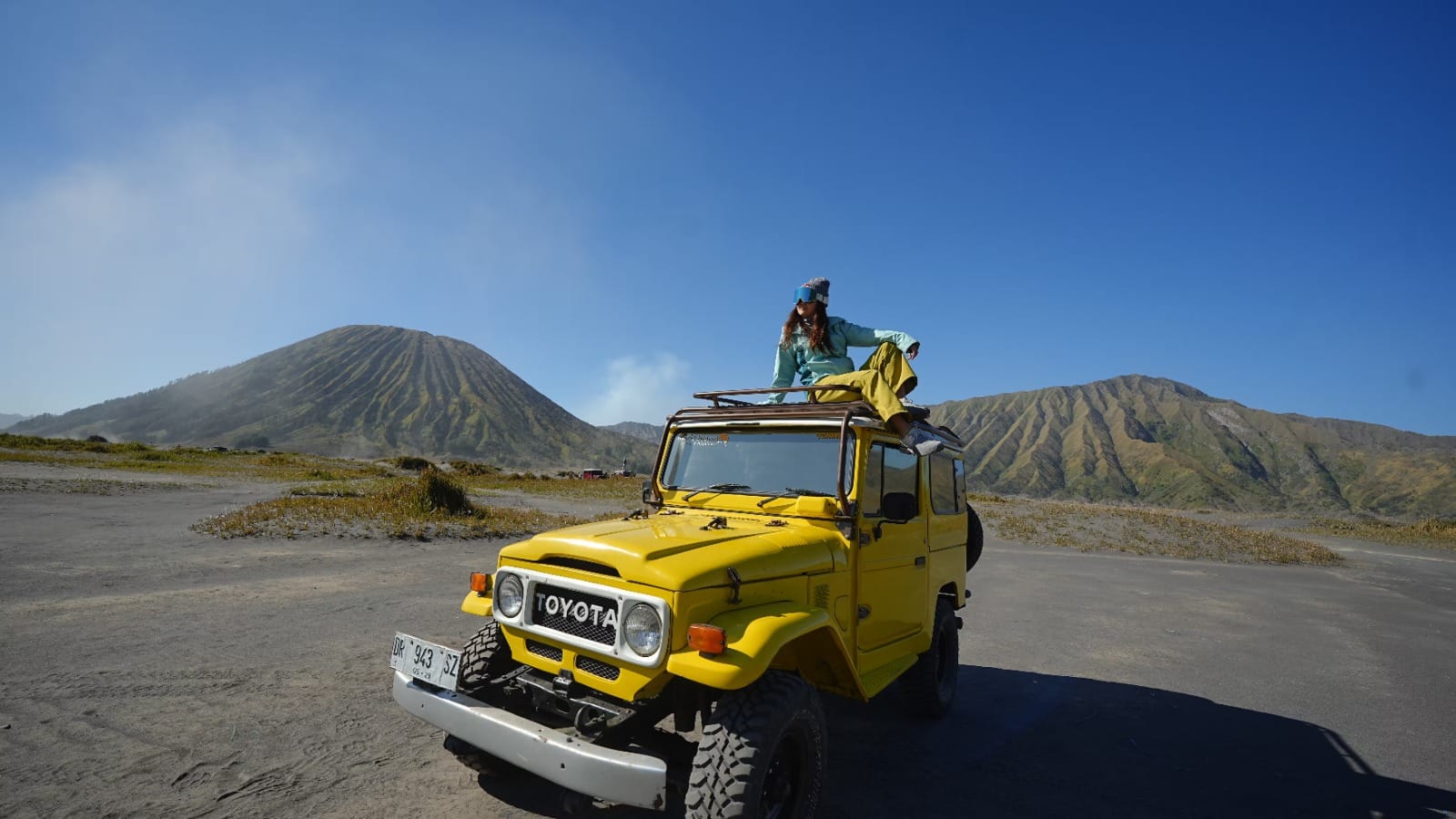 Tourists riding jeep across the Sea of Sand in Bromo Tengger Semeru National Park
