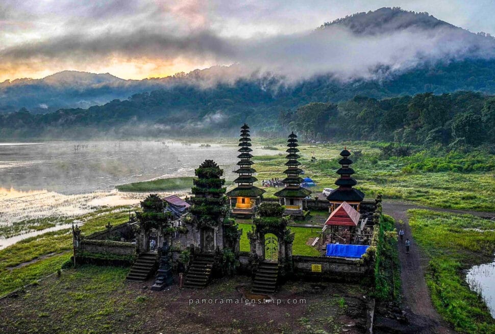 Ulun Danu Beratan Temple in Bali during traditional Balinese ceremonies, surrounded by misty mountains and sacred lake scenery.