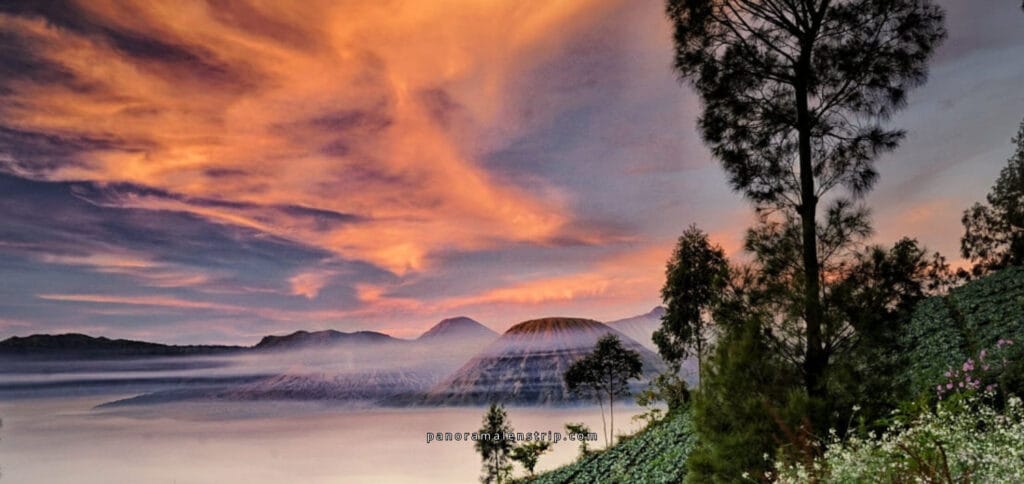 Peaceful Bromo Sunrise scene with colorful sky, volcanic peaks, and morning mist in East Java