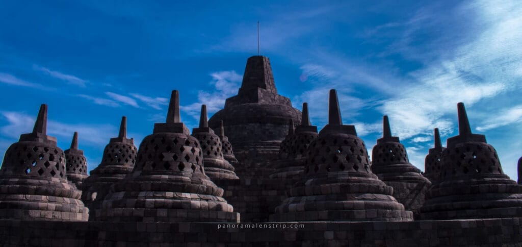 Borobudur Temple stupas under blue sky showcasing the history of Borobudur Temple in Central Java, Indonesia