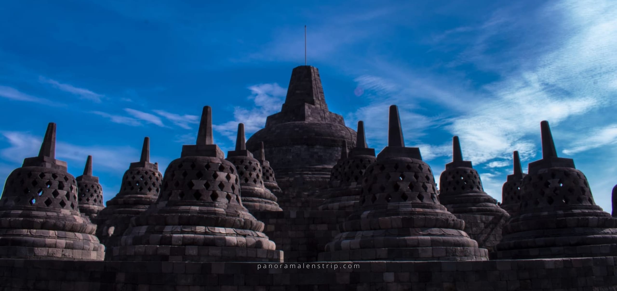 Borobudur Temple stupas under blue sky showcasing the history of Borobudur Temple in Central Java, Indonesia
