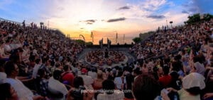 Crowd watching the Kecak fire dance performance at Uluwatu Temple in Bali during sunset