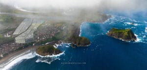 Aerial view of Papuma Beach cliffs and blue ocean waves near Jember East Java