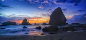 Papuma Beach sunrise with dramatic rock formations and colorful sky in East Java