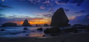 Papuma Beach sunrise with dramatic rock formations and colorful sky in East Java