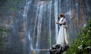 upward shot of Tumpak Sewu waterfall from bottom with tall cascades and mist