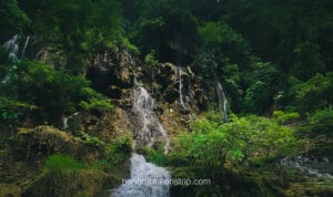 cave-like Goa Tetes rock formations with dripping waterfalls and textured cliffs