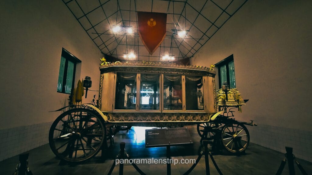 Traditional royal carriage Kyai Roto Projo displayed inside the Yogyakarta Royal Palace museum hall
