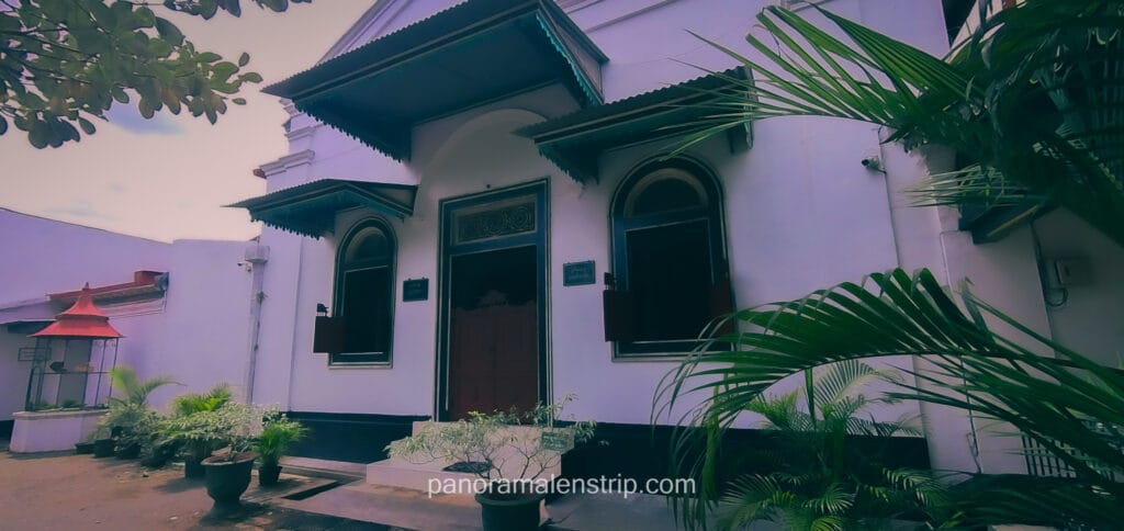Exterior view of the Yogyakarta Royal Palace museum building with colonial-Javanese architecture and garden plants