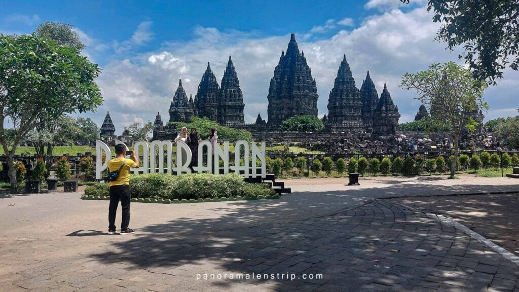 History of Prambanan Temple highlighted at the Prambanan landmark sign with visitors and the iconic Hindu towers in Yogyakarta, Indonesia.