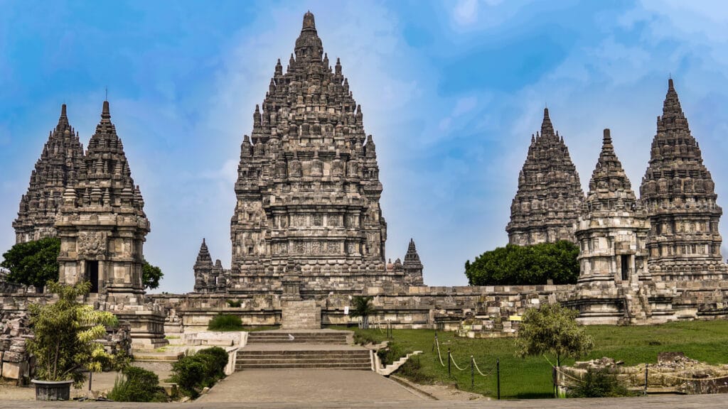 Prambanan photography guide showcasing symmetrical Hindu temple spires at Prambanan Temple in Yogyakarta under clear blue sky