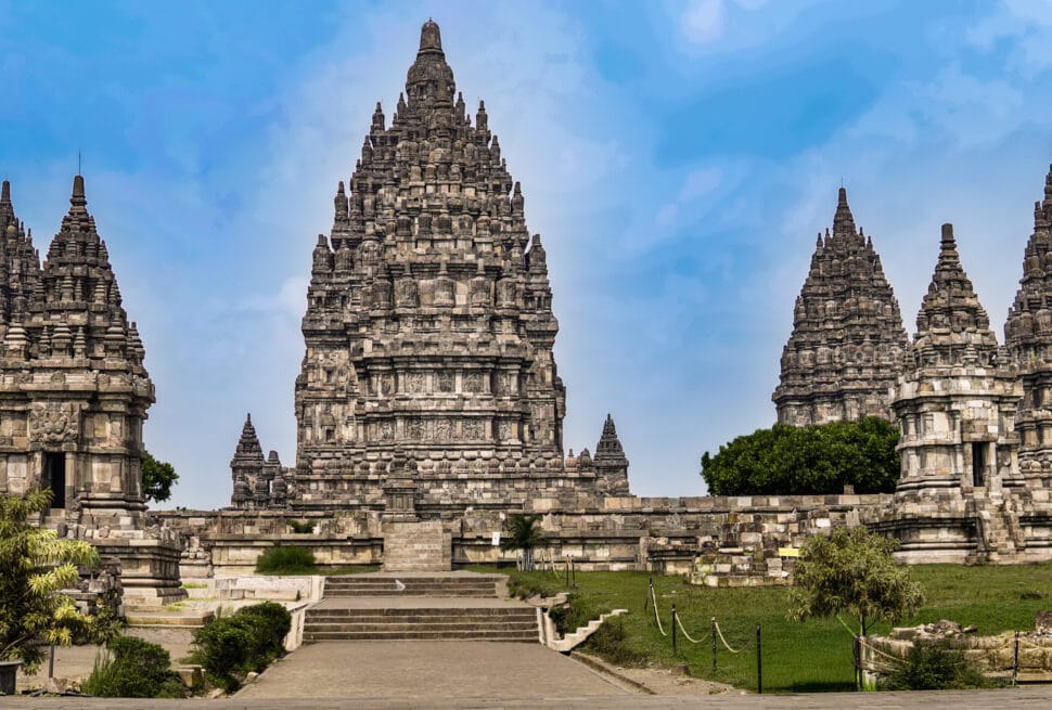 Prambanan photography guide showcasing symmetrical Hindu temple spires at Prambanan Temple in Yogyakarta under clear blue sky