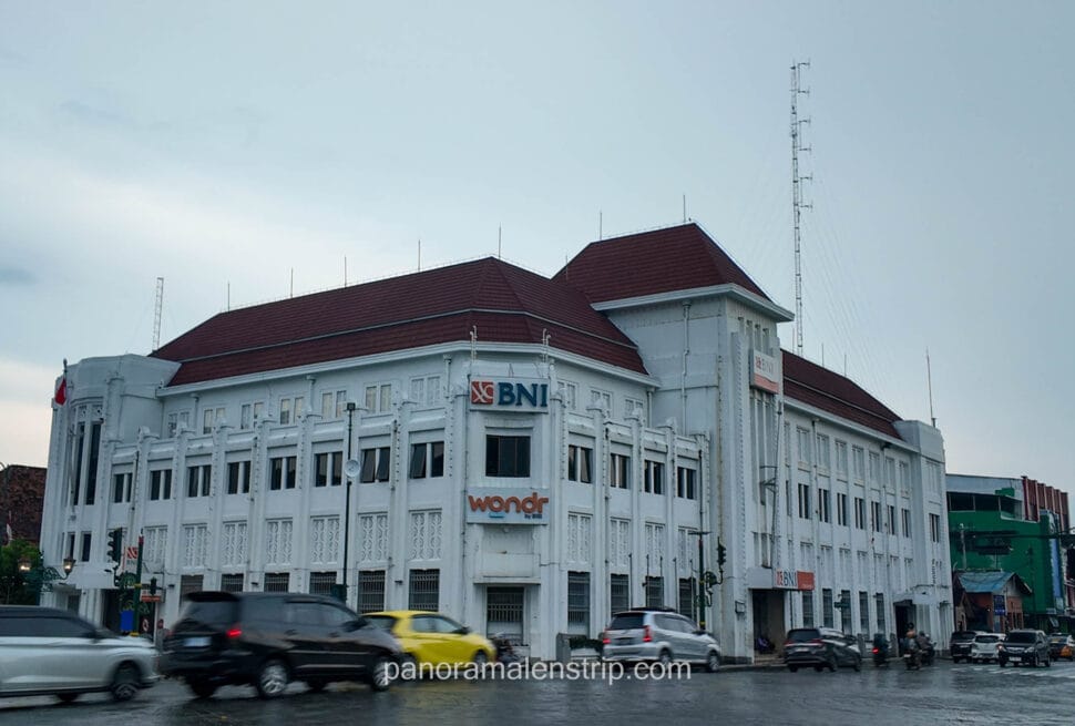 The historic white BNI building with Dutch colonial architecture at the Zero Kilometer intersection in Yogyakarta.