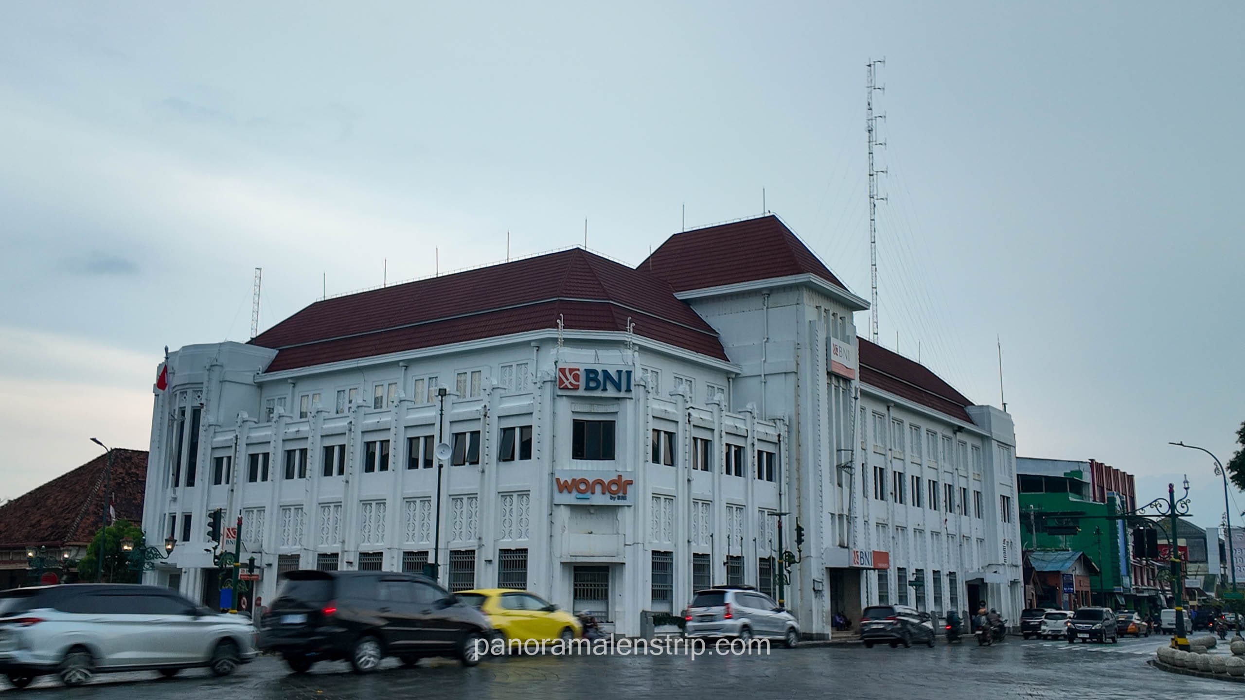 The historic white BNI building with Dutch colonial architecture at the Zero Kilometer intersection in Yogyakarta.