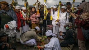 Tenggerese locals and priests preparing traditional Hindu offerings on the Mount Bromo caldera during the Yadnya Kasada ceremony.