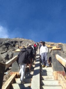 Many tourists walking up and down the crowded stairs to Mount Bromo crater rim, a common sight encountered before or after completing the King Kong Hill trekking.