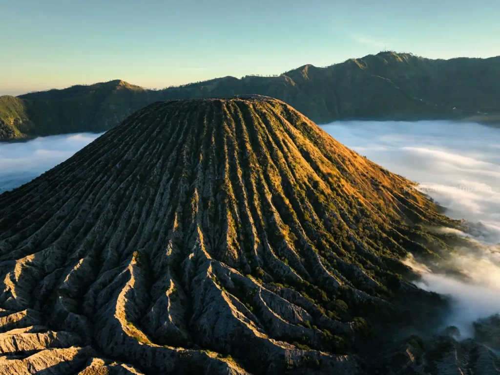 Sea of clouds at Mount Batok during golden hour on a Mount Bromo trekking tour