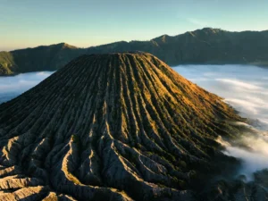 Sea of clouds at Mount Batok during golden hour on a Mount Bromo trekking tour