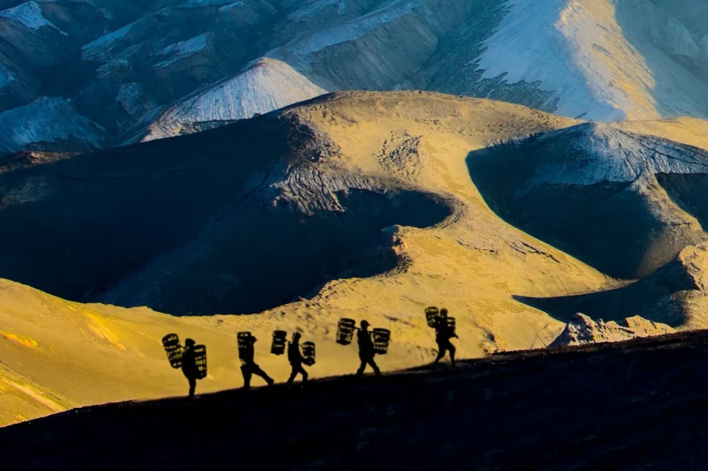 Lunar-like environment of the Bromo ash basin during golden hour on a Mount Bromo trekking tour