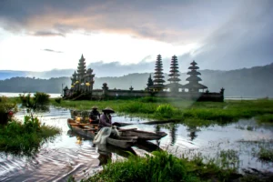 Traditional wooden canoe on Tamblingan Lake during a premium Bali temple tour.