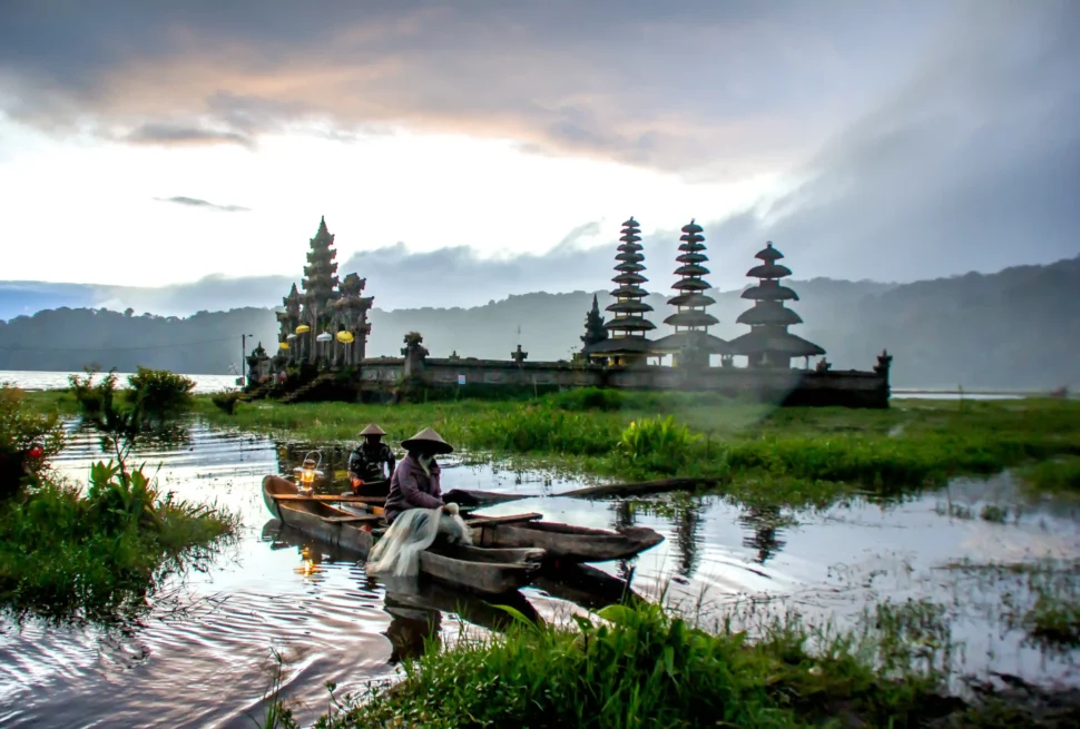 Traditional wooden canoe on Tamblingan Lake during a premium Bali temple tour.