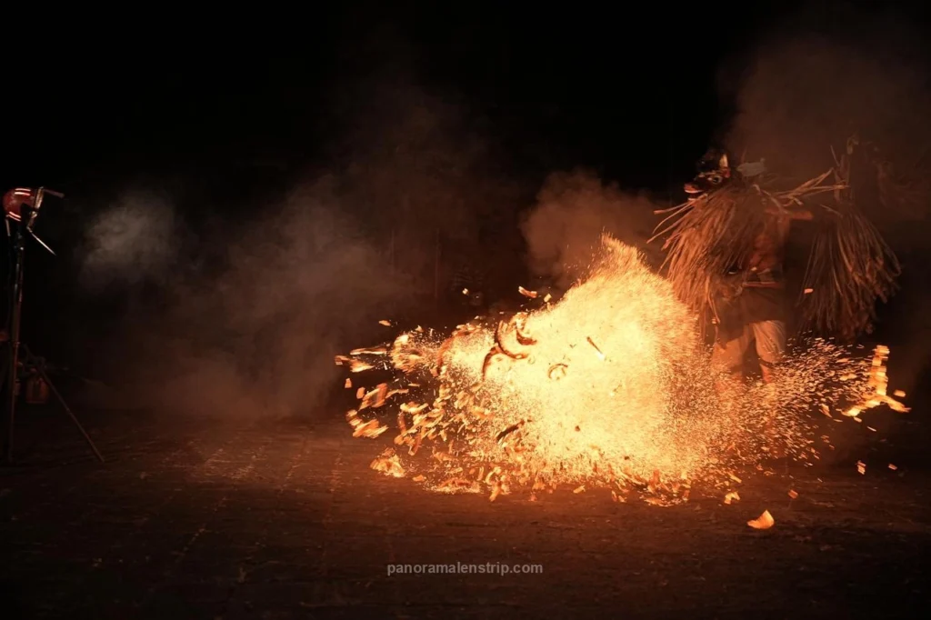 Close-up detail of fire and embers from the powerful kicks of a male dancer in a Bali traditional dance performance.