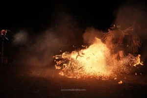Close-up detail of fire and embers from the powerful kicks of a male dancer in a Bali traditional dance performance.