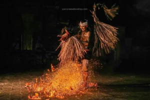 A joyful dancer smiles while dancing over fire with a hobby horse prop.