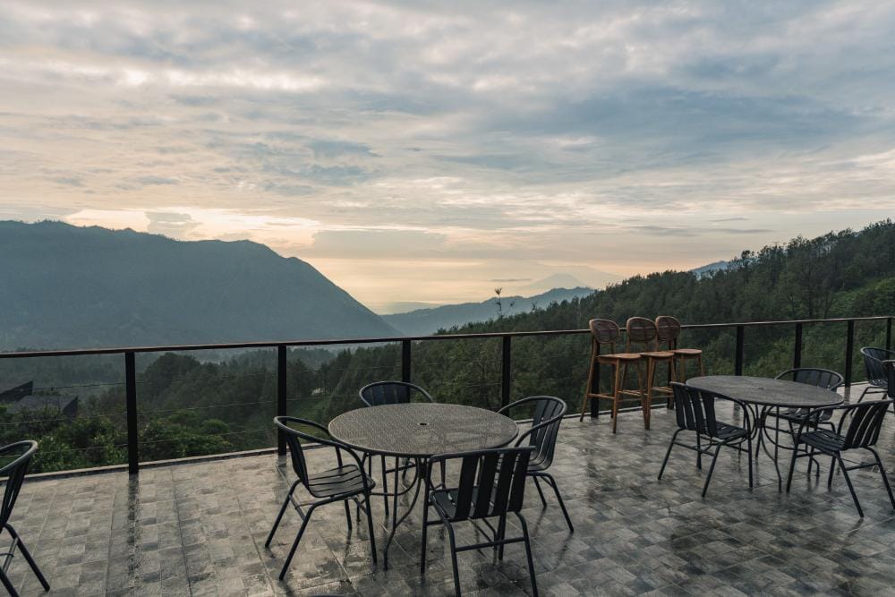Outdoor restaurant terrace at Artotel Bromo with sunrise mountain views