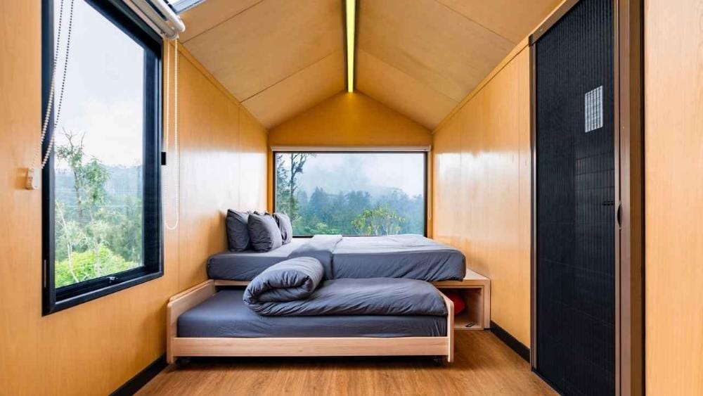 Modern IoT-enabled cabin room interior at Bobo Cabin Hotel Paltuding with minimalist beds and scenic forest views