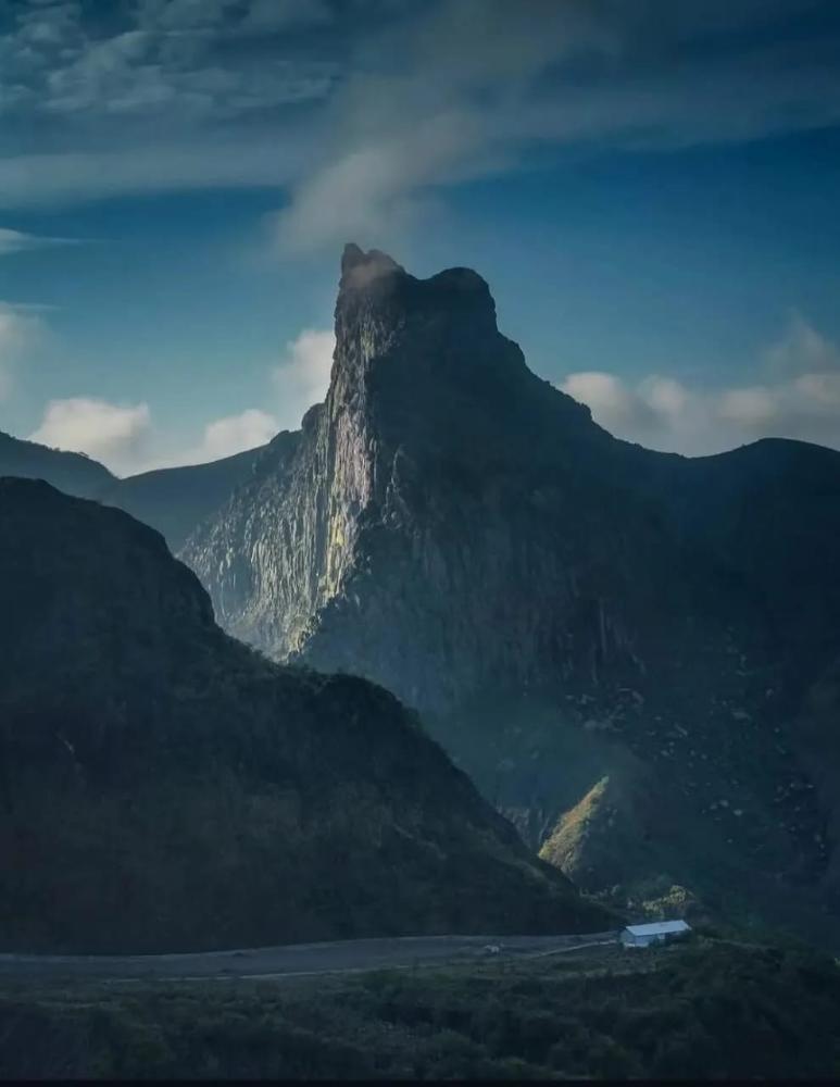 Entrance road to Kelud Crater with dramatic volcanic cliffs and mountain scenery