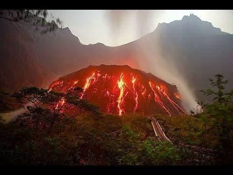 Evening view of the Kelud lava dome before the 2014 eruption, glowing red under the fading light.