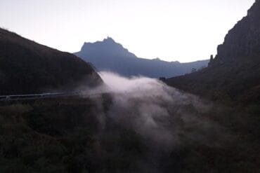 Drone view of Mount Kelud landscape before sunrise with mist rising through the valley