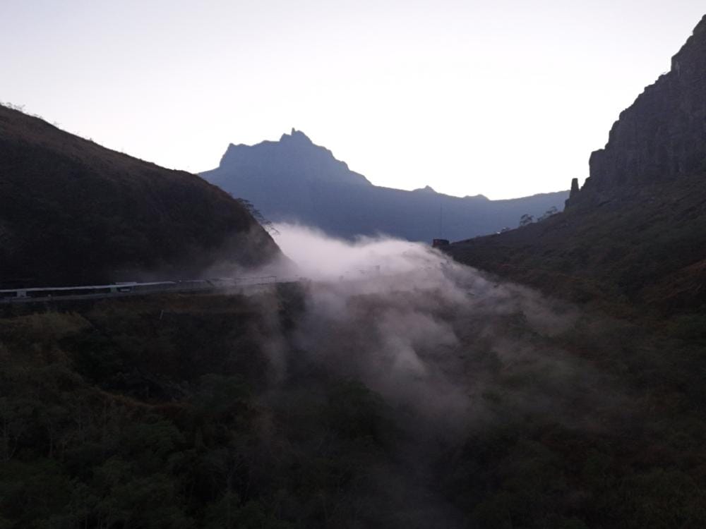 Drone view of Mount Kelud landscape before sunrise with mist rising through the valley