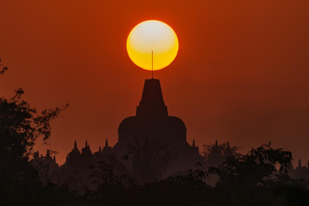 Perfectly aligned sunrise over Borobudur Stupa silhouette at Puthuk Situmbu
